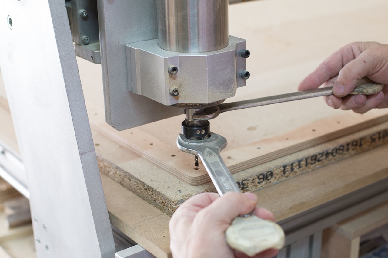 Inserting a router bit into a CNC milling machine